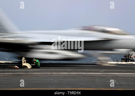 190516-N-FQ836-0276 ARABIAN SEA (May 16, 2019) Aviation Boatswain's Mate (Equipment) Airman Kayla Pettit operates a center deck station as an F/A-18F Super Hornet from the 'Sidewinders' of Strike Fighter Squadron (VFA) 86 Launches on the flight deck of the  Nimitz-class aircraft carrier USS Abraham Lincoln (CVN 72). Abraham Lincoln Carrier Strike Group (CSG) 12 is prepared to respond to contingencies and to defend U.S. forces and interests in the region. With Abraham Lincoln as the flagship, deployed strike group assets include staffs, ships and aircraft of Carrier Strike Group 12 (CSG 12), De Stock Photo