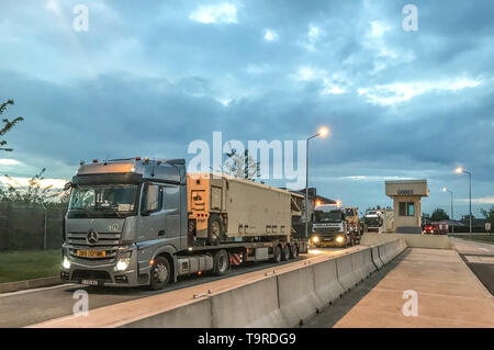 MIHAIL KOGALNICEANU (MK) AIR BASE, ROMANIA – A convoy of Romanian trucks carrying a Terminal High Altitude Area Defense (THAAD) interceptor system leave Mihail Kogalniceanu (MK) Air Base, Romania, in route to Naval Support Facility Deveselu, Romania May 10. The 400-kilometer convoy was the longest the THAAD system has traveled on road outside of the continental U.S. The deployment of the THAAD is in support of the NATO Ballistic Missile Defense mission and reinforces the strong and unremitting U.S. commitment to the defense of our NATO allies. (Photo by U.S. Army Master Sgt. James Redd, 174th  Stock Photo