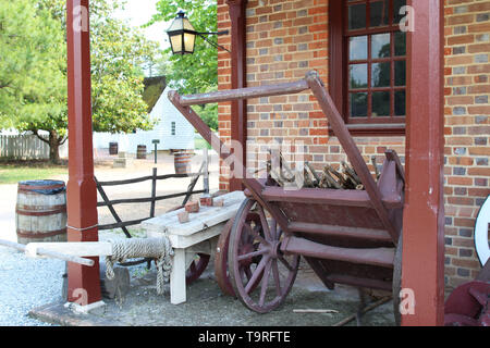 Open storage shed with a vintage wooden cart and farming too Stock Photo