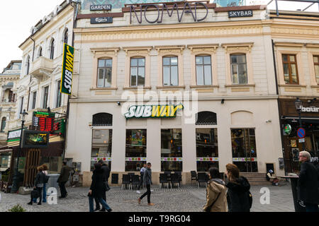 Bucharest, Romania - March 16, 2019: Tourists walking by Subway restaurant on Lipscani street in Old Town part of Bucharest, Romania. Stock Photo