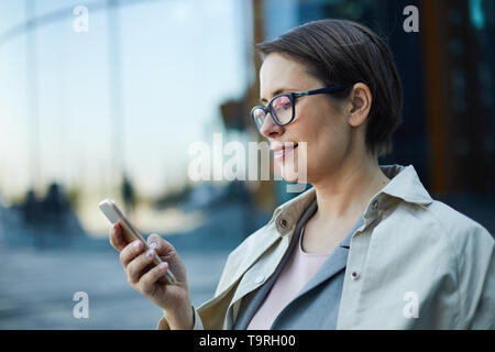 Lady using mobile app Stock Photo