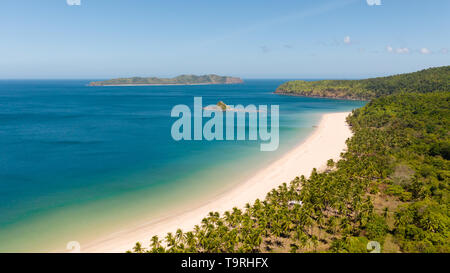 aerial view island with tropical sandy beach and palm trees. Malajon Island, Philippines, Palawan. tourist boats on coast tropical island. Summer and travel vacation concept. beach and blue clear sea water Stock Photo