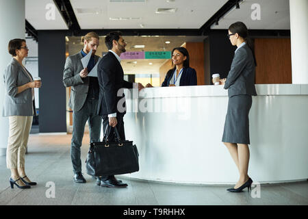 Businessman checking in to hotel Stock Photo