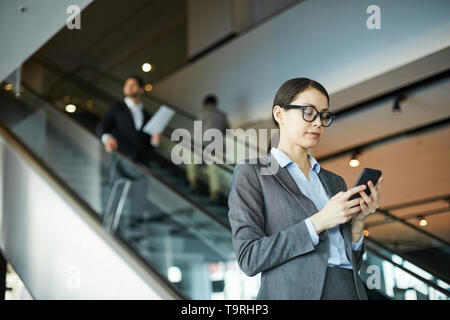Young woman checking email on smartphone Stock Photo
