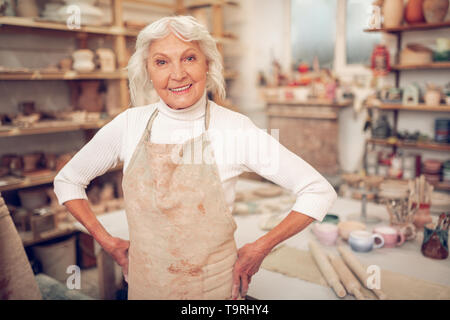 Joyful grey haired woman smiling to you Stock Photo