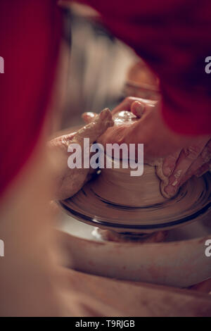 Nice pleasant people making pots from clay Stock Photo