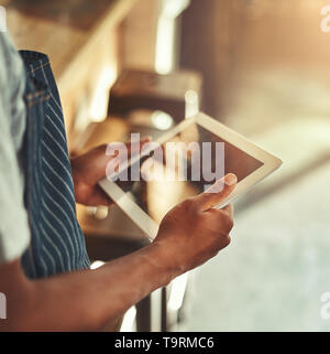 Cafe owner holding digital tablet in hands Stock Photo