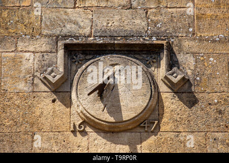 Detail of a sundial on a 17th century Cotswold stone building in the High Street of Chipping Campden, England Stock Photo