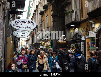 Tourists and locals walking down the narrow streets in the historic centre of Naples, Italy Stock Photo
