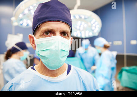 Portrait of senior surgeon in operating room Stock Photo