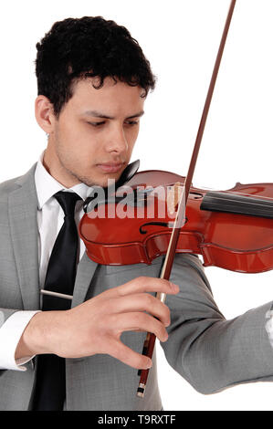 A young handsome man in a gray suit playing the violin, looking concentrated serious, isolated for white background Stock Photo