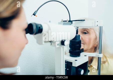 Senior woman having eyesight examination at doctor office Stock Photo