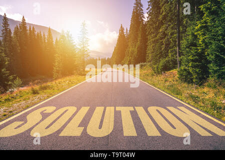 Solution written on road in the mountains. Solution text on the road. Stock Photo