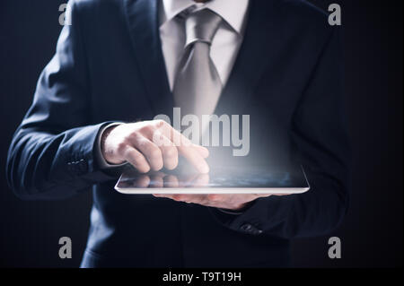 Close up of a businessman hand using digital tablet Stock Photo