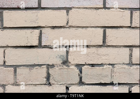 Old painted beige color weathered stained brick wall for texture or background Stock Photo