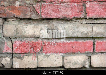 Weathered stained old brick wall for texture or background Stock Photo
