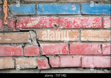Weathered stained old brick wall for texture or background Stock Photo