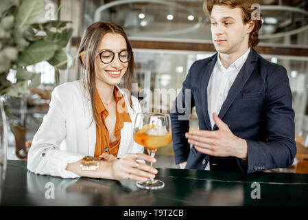 Business partners having unofficial meeting, drinking together some cocktails at the bar Stock Photo