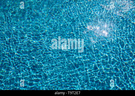 Blue ripped water in swimming pool. Surface of blue swimming pool, background of water in swimming pool. Water swimming pool texture and surface water Stock Photo