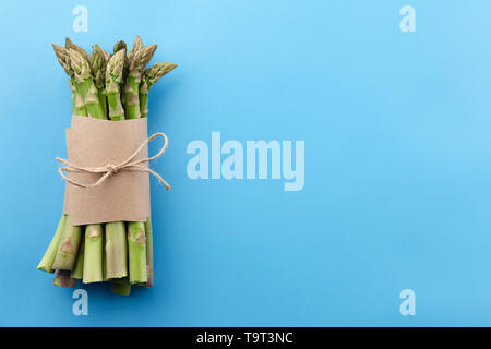 Bunch of green asparagus on blue background Stock Photo