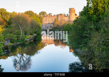 Warwick castle and river avon reflections at sunrise in the spring. Warwick, Warwickshire, England Stock Photo