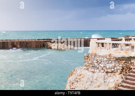 Coastal landscape with concrete breakwater in stormy sea. Alexandria, Egypt Stock Photo