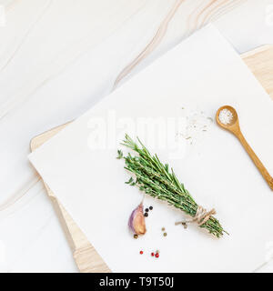 Flat lay overhead top view of greens herbs and spices on white marble background with copy space. Menu frame design food pattern background with cooki Stock Photo