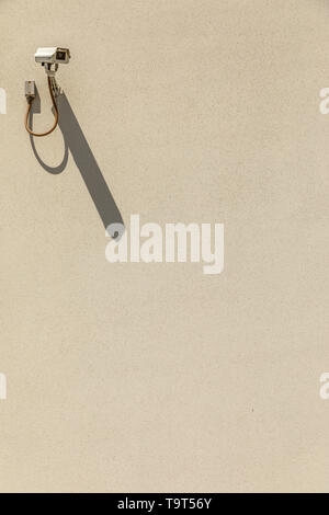 Surveillance camera on an empty wall Stock Photo