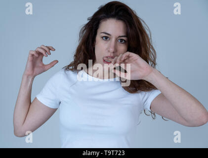 Young woman with red hair confused and displeased staring in disgust. Looking puzzled not understanding or liking something. Portrait with copy space. Stock Photo