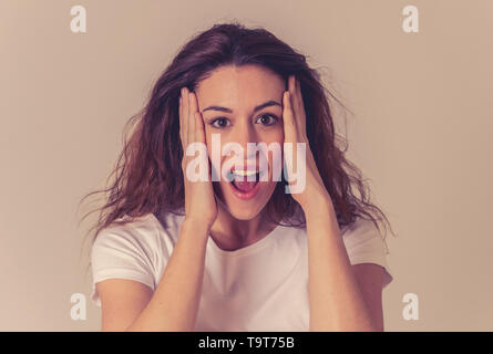 Beautiful young red hired woman with happy face making surprised gestures and looking at something shocking and good. Human facial expressions and emo Stock Photo