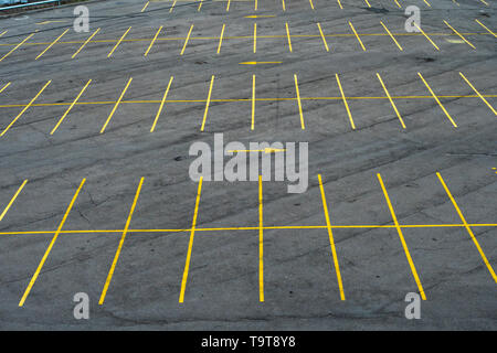 The marking lines in the parking lot with yellow paint on asphalt. Large parking lot, empty Stock Photo