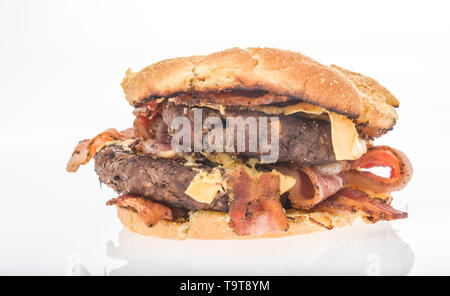 A double burger with cheese and lots of bacon on an isolated background Stock Photo