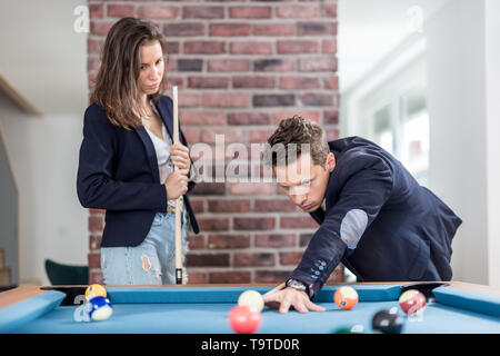 Fashionable couple playing snooker. Stock Photo