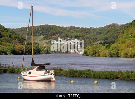 Village of Brodenbach on the banks of the Moselle river in Germany with moored boats Stock Photo