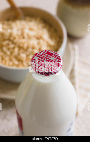 Fresh semi skimmed milk in a recyclable glass bottle delivered to the door step by  a traditional milk man Stock Photo