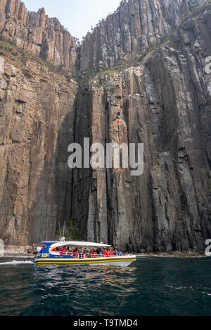 Tourist Boat, Cliffs and Sea at Bruny Island, Tasmania Stock Photo