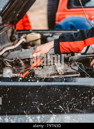 Jump-Starting the Dead Battery using jumper electrical wires. Stock Photo