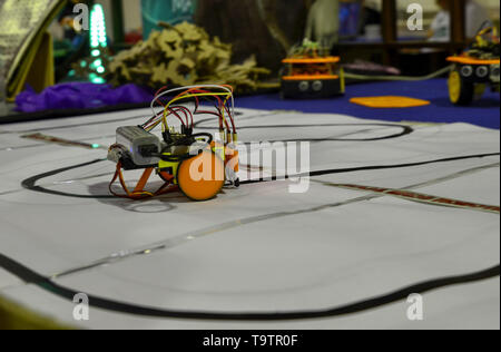 Turin, Piedmont, Italy. June 3 2018. At the Fablab of Turin a demo with a small robot equipped with sensors that allow him to follow a line, making hi Stock Photo