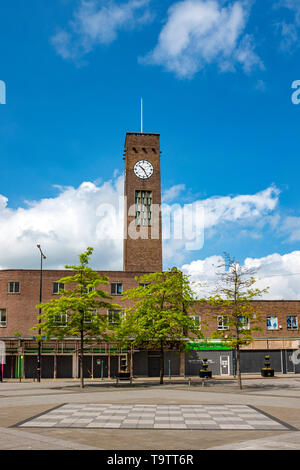 Boarded up shops with clock tower and foundation of removed war memorial in town centre of Crewe Cheshire UK Stock Photo