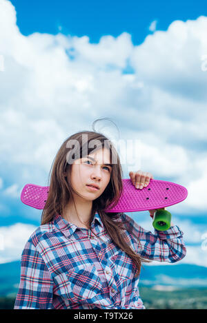 plastic mini cruiser board. Spring. Urban scene, city life. ready to ride on the street. Hipster girl with penny board. skateboard sport hobby. Summer Stock Photo