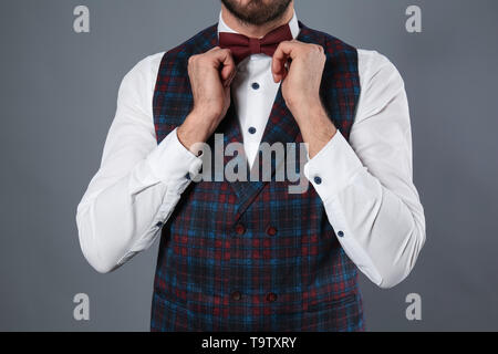 Fashionable young man in formal clothes on grey background Stock Photo