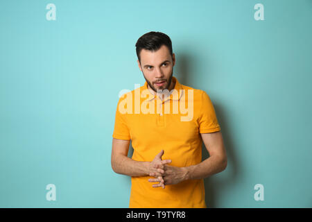 Fashionable young man on color background Stock Photo