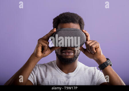Closeup portrait of afro american man wearing VR goggles, working over virtual project, enjoying new reality, playing video game, posing isolated agai Stock Photo