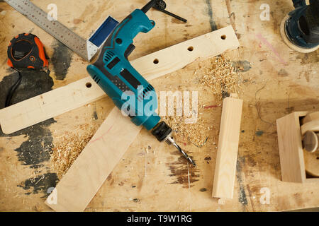 Above view background of tools and wood lying on table in carpenters workshop, copy space Stock Photo