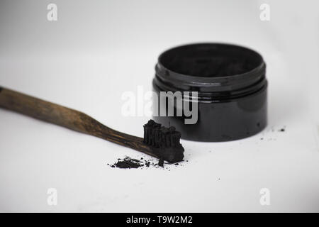 Charcoal on a toothbrush to whiten teeth Stock Photo