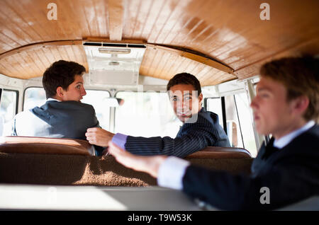 Three teenage boys in vintage car before prom. Stock Photo