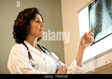 Female doctor examining an x-ray. Stock Photo