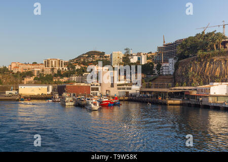 Portugal, Funchal - July 31, 2018: View of the port of the city from the departing ship in the early morning. Stock Photo