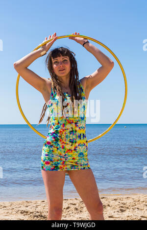Southbourne, Bournemouth, Dorset, UK. 21st May, 2019. UK weather: lovely warm sunny morning as Lottie Lucid performs her hula hooping routine on the beach at Southbourne, enjoying the warm sunny weather in her mini dress. Credit: Carolyn Jenkins/Alamy Live News Stock Photo