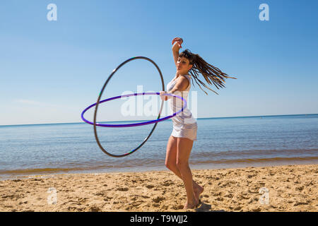 Southbourne, Bournemouth, Dorset, UK. 21st May, 2019. UK weather: lovely warm sunny morning as Lottie Lucid performs her hula hooping routine on the beach at Southbourne, enjoying the warm sunny weather in her mini dress. Credit: Carolyn Jenkins/Alamy Live News